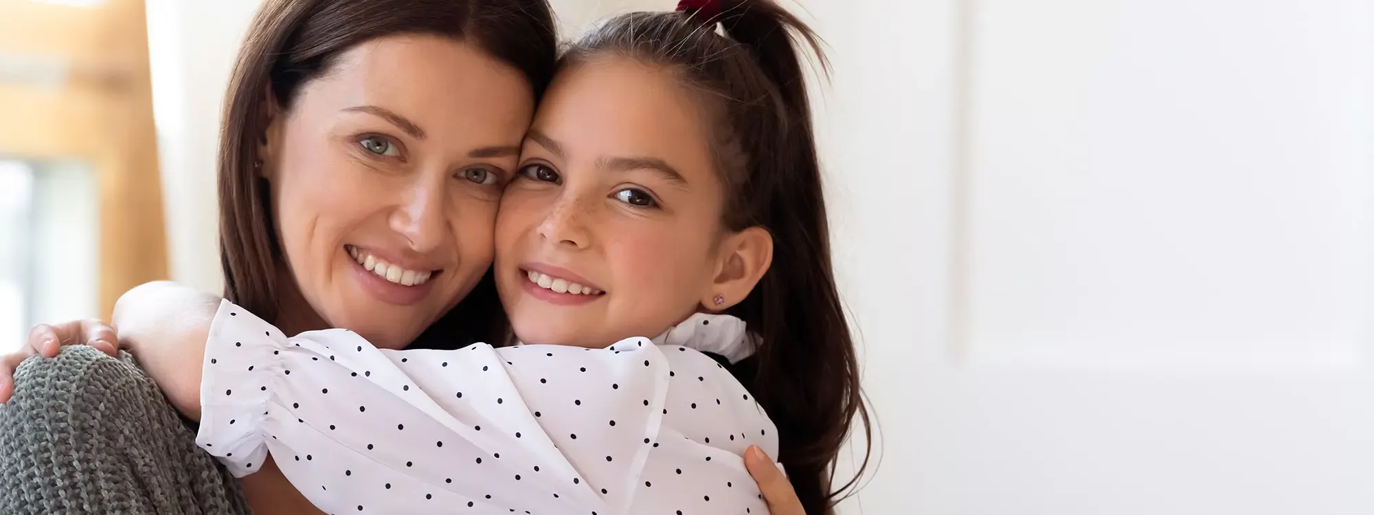 Mother hugging her daughter